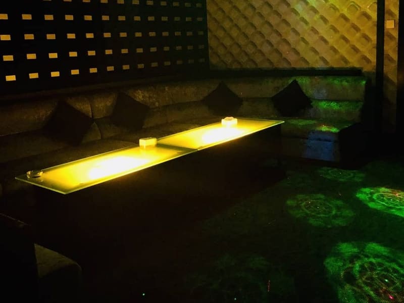 Private room with a lit table and padded walls at V3 KTV, Pulau Tikus, Penang